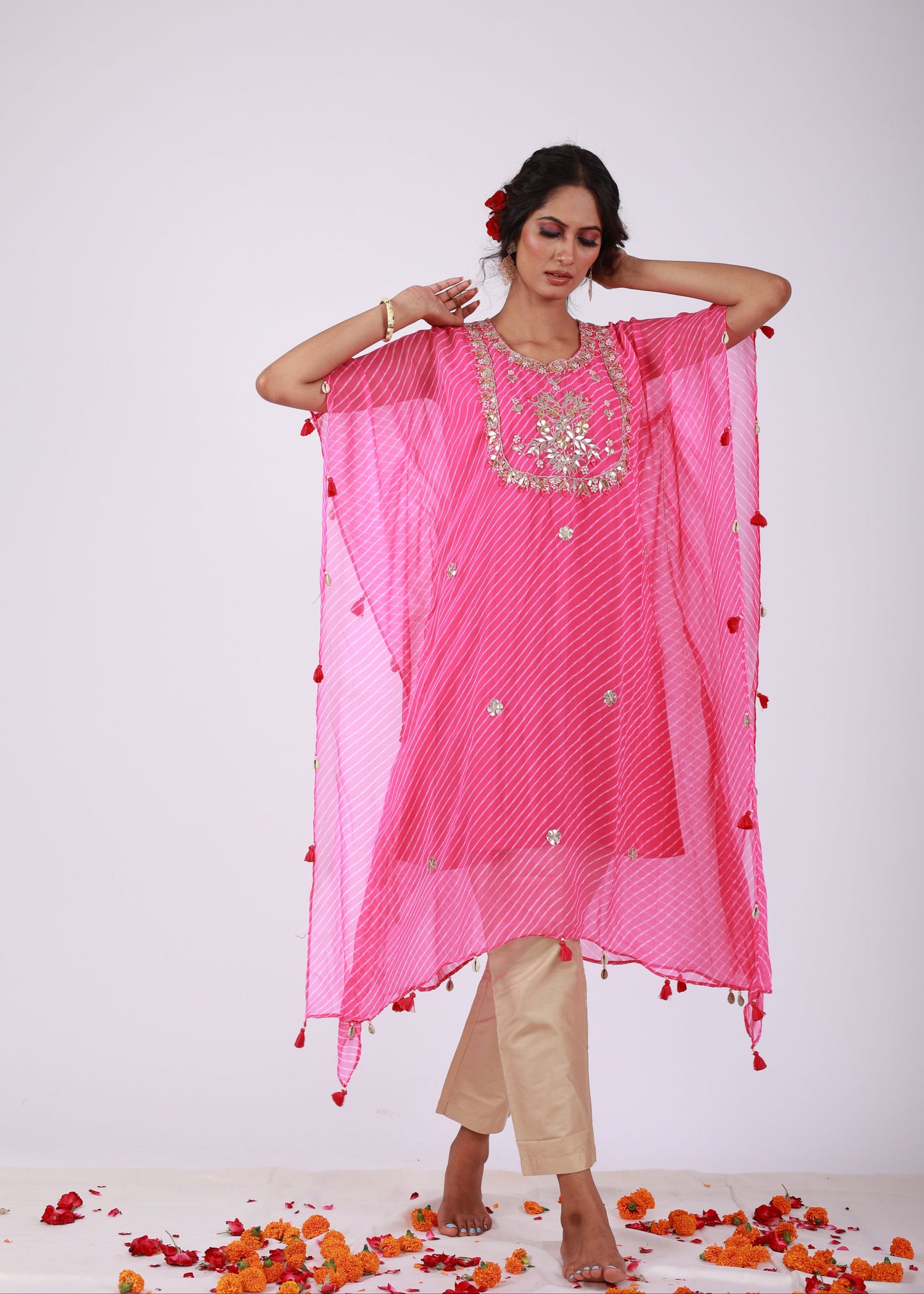 Model wearing the Roobroo pink georgette kaftan with gota patti embroidery, tassels, and light gold jam silk pants – a playful piece from That Romeo’s Roobroo Collection.