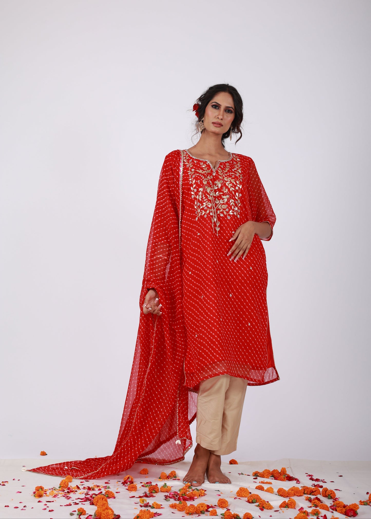 Model wearing Roobroo red Bandhani georgette kurta set with gota patti and zari embroidery, styled with light gold jam silk pants – That Romeo’s Roobroo Collection.