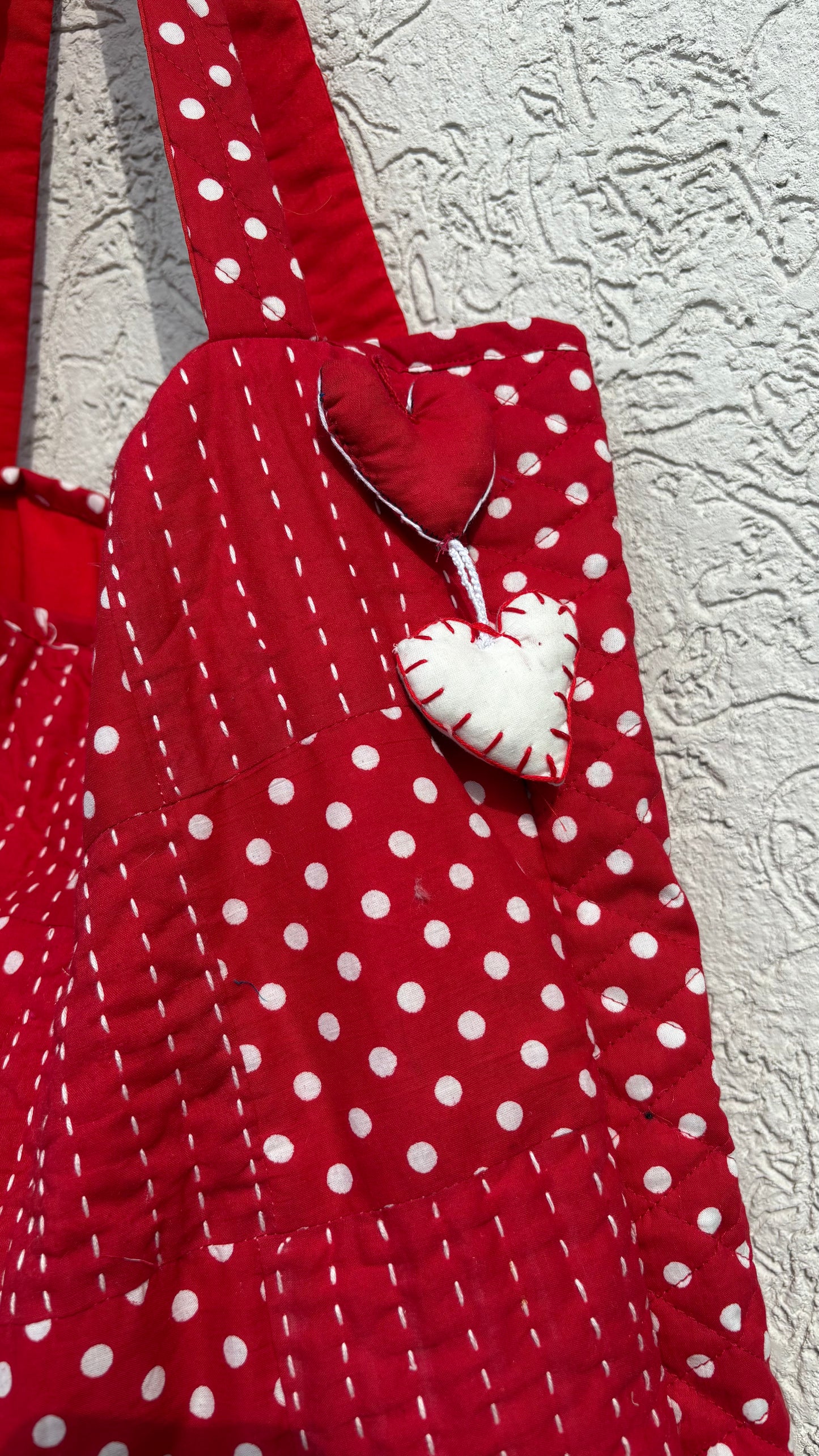 Handcrafted red quilted tote bag with polka dot patchwork, Kantha embroidery, and heart charm — eco-conscious and artisan-made by That Romeo