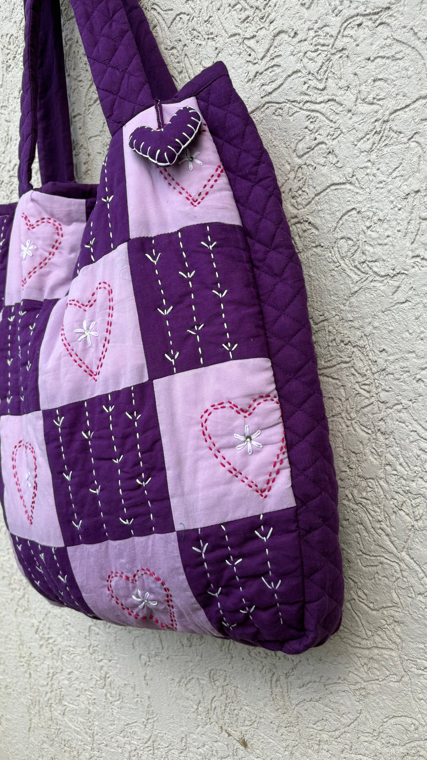 Handmade purple and lavender tote bag with heart-shaped Kantha embroidery, quilted design, and heart charm — eco-friendly and artisan-crafted by That Romeo