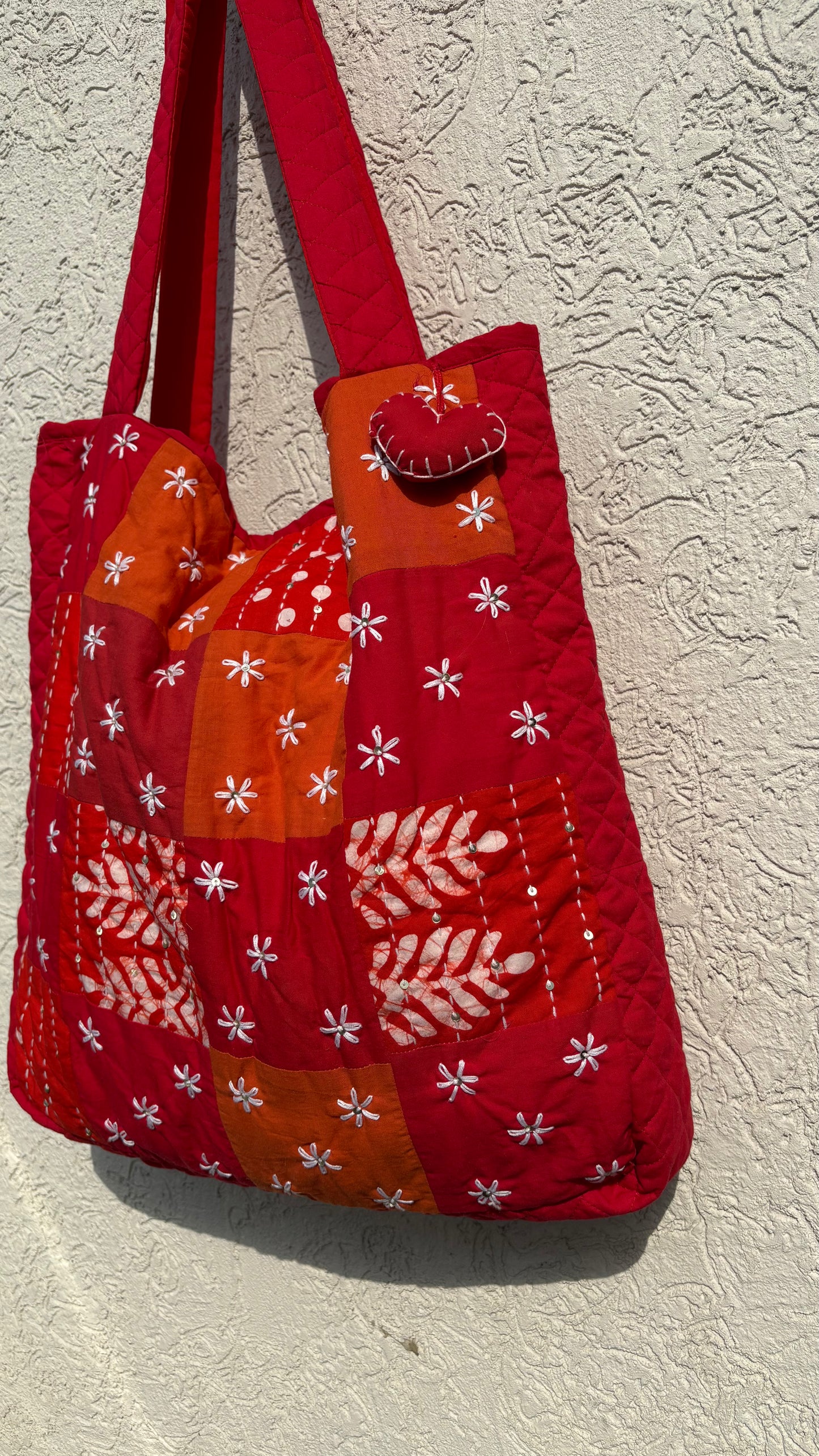 That Romeo handmade tote bag with floral Kantha embroidery, red-orange patchwork, and heart charm — eco-conscious, upcycled, and artisan-crafted