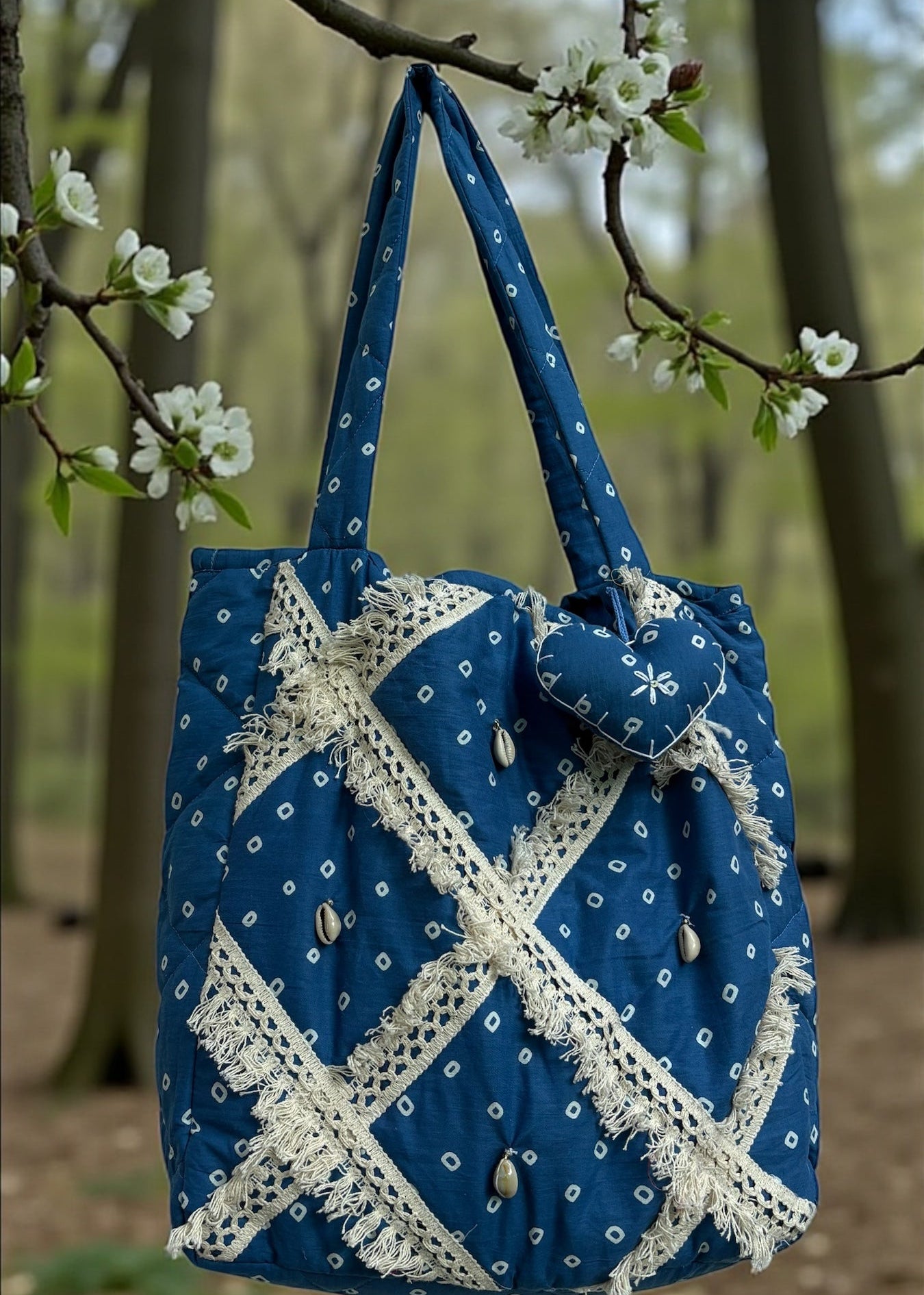 Blue Bandhani quilted tote bag by That Romeo with lace patchwork and shell embellishments.