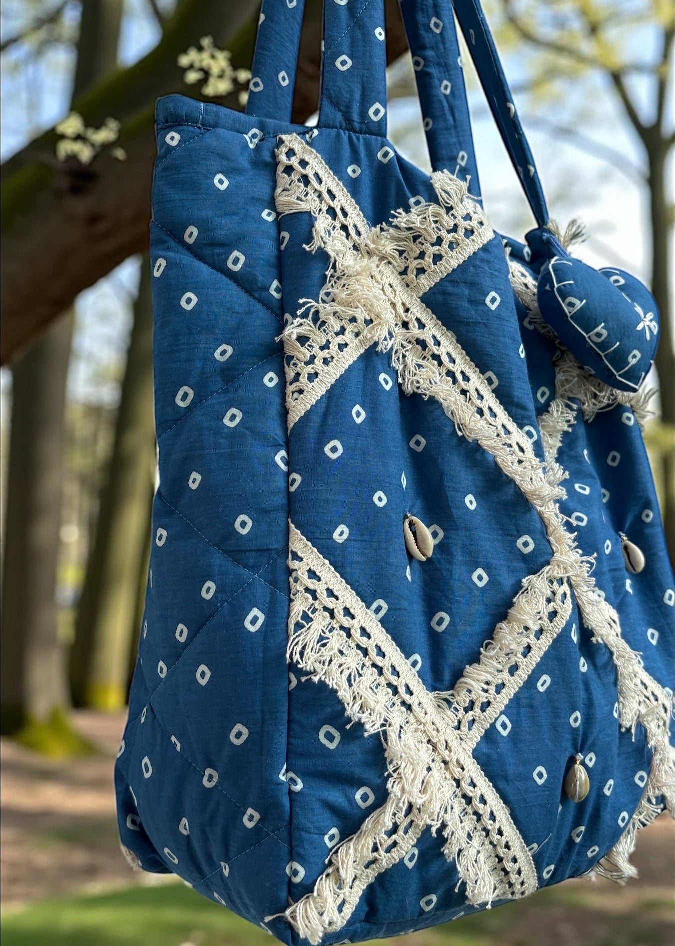 Blue Bandhani quilted tote bag by That Romeo with lace patchwork and shell embellishments.