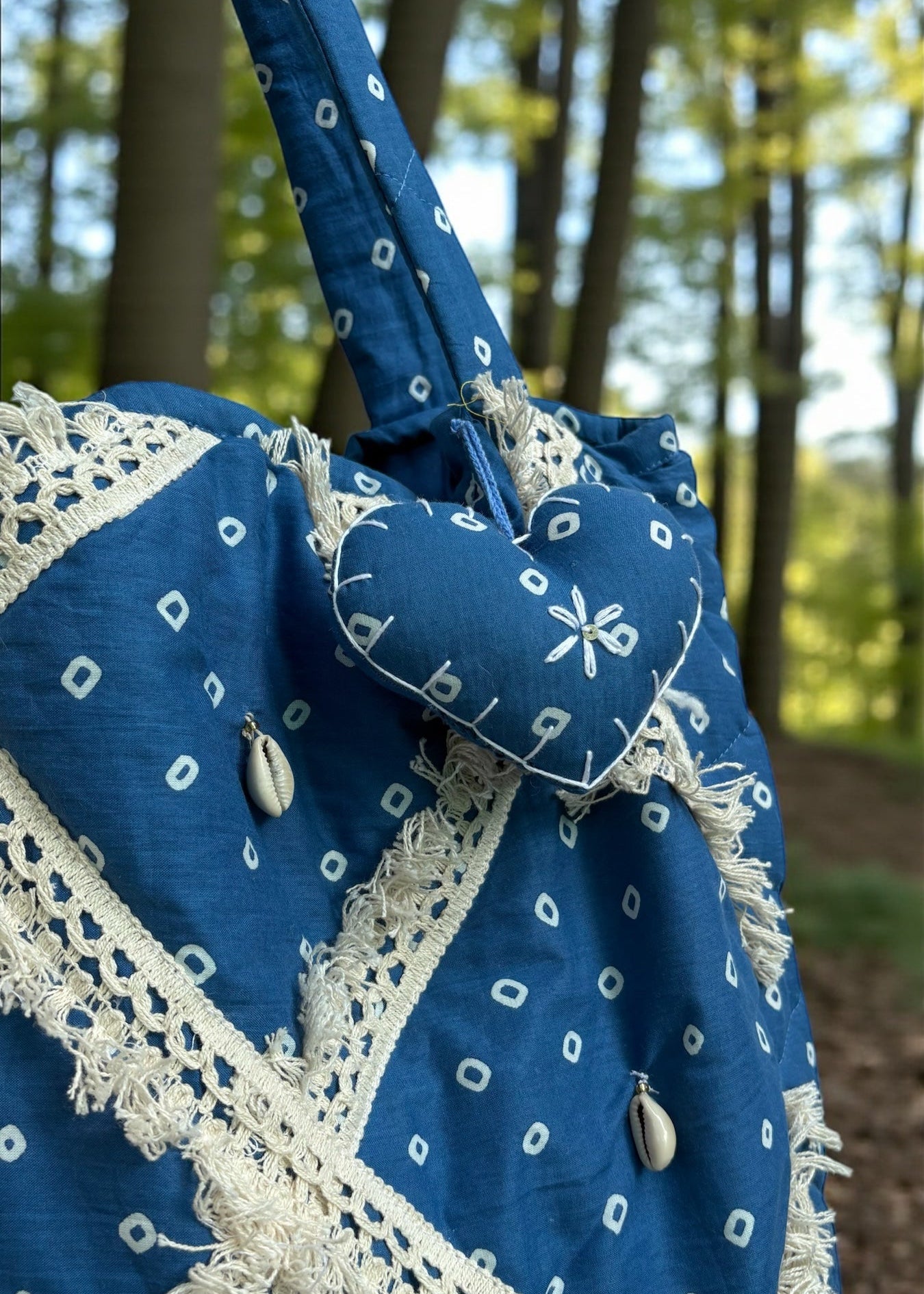 Blue Bandhani quilted tote bag by That Romeo with lace patchwork and shell embellishments.