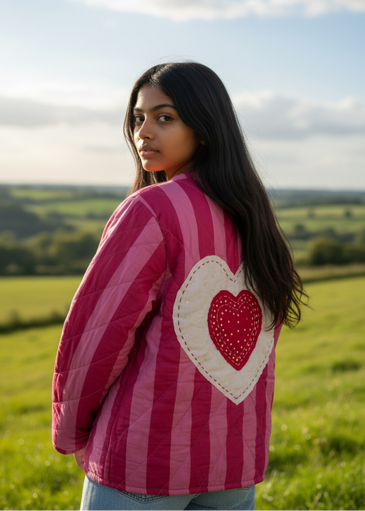 Model wearing ThatRomeo’s Sweetheart Patch Quilted Jacket — pink striped cotton jacket with heart patches and relaxed open front.