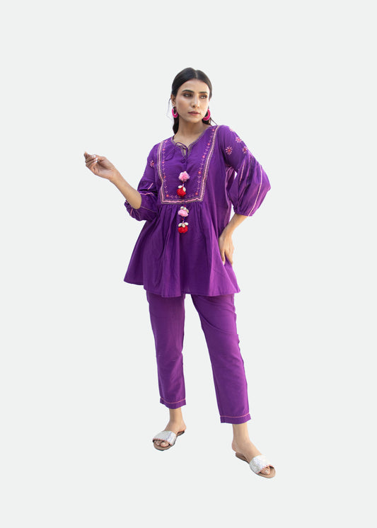 Model wearing the ASHIRA purple cotton co-ord set with Katha embroidery, puff sleeves, and a tassel-tied neckline – a regal festive look from That Romeo’s PARDESI Collection.