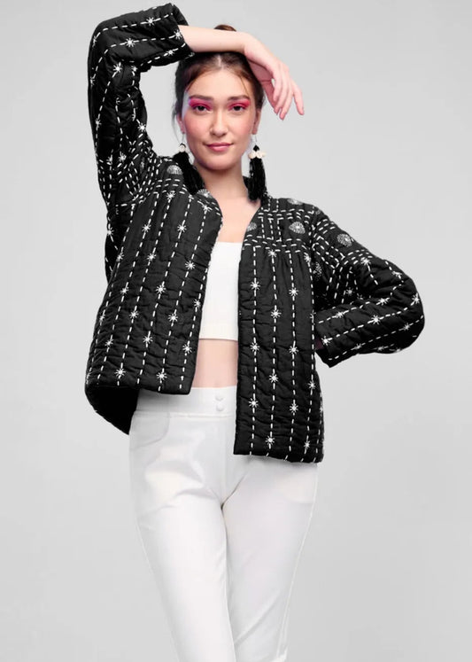 Model wearing a black hand-quilted jacket with white Katha embroidery, paired with a white crop top and trousers, showcasing the Zayla jacket's celestial design.