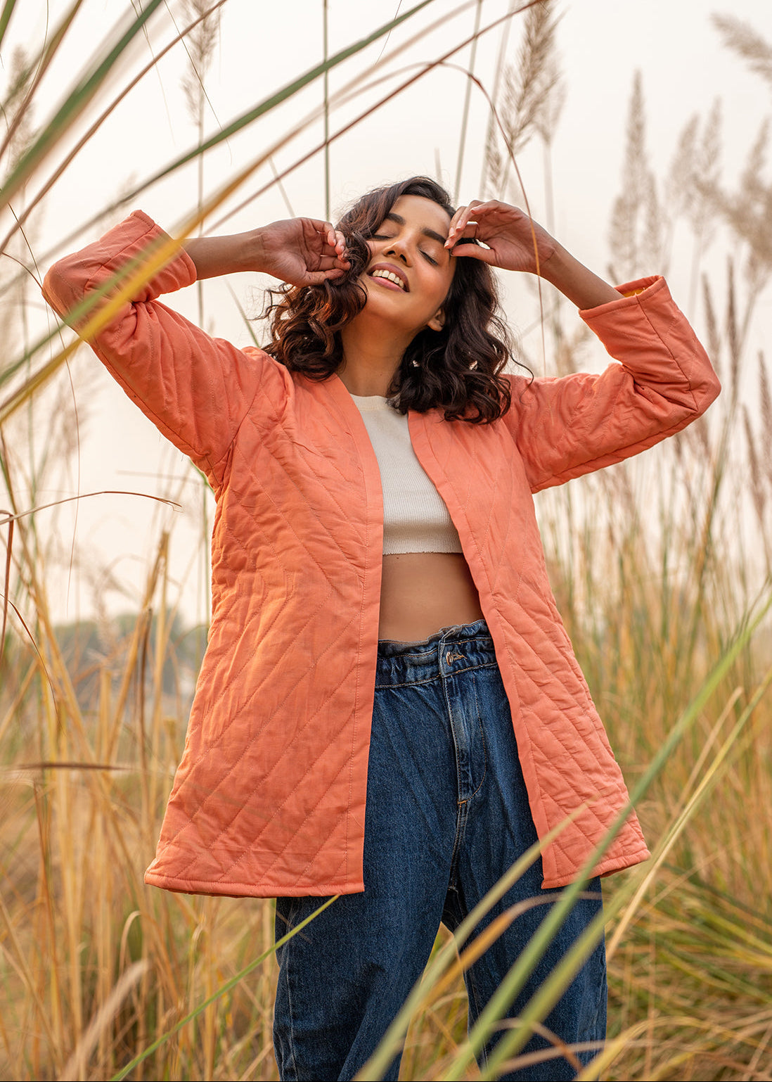 Model wearing ThatRomeo’s Cheery Peach Quilted Jacket — longline peach cotton jacket with open front and relaxed fit.