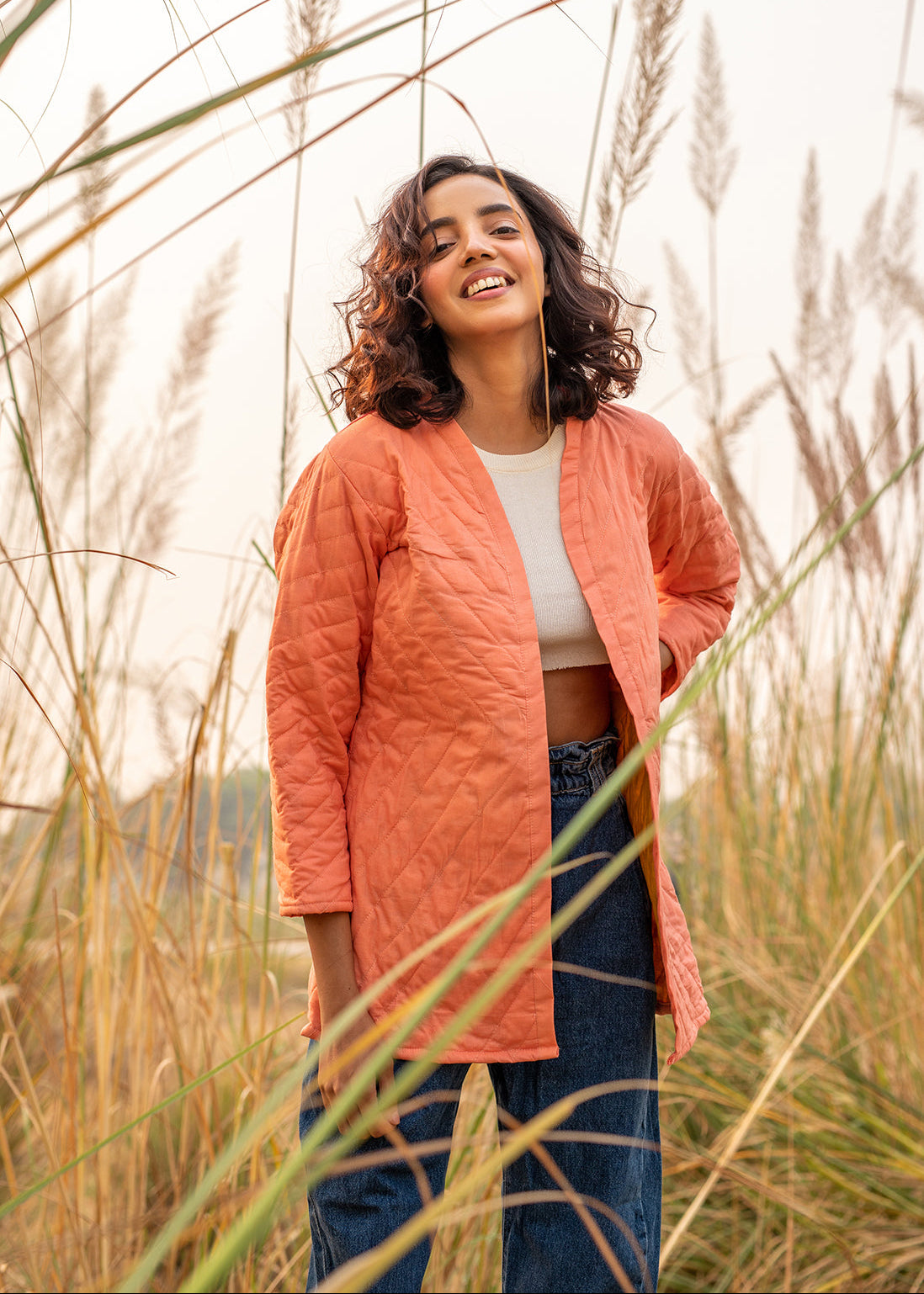 Model wearing ThatRomeo’s Cheery Peach Quilted Jacket — longline peach cotton jacket with open front and relaxed fit.