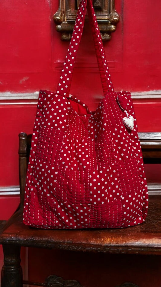 Handcrafted red quilted tote bag with polka dot patchwork, Kantha embroidery, and heart charm — eco-conscious and artisan-made by That Romeo