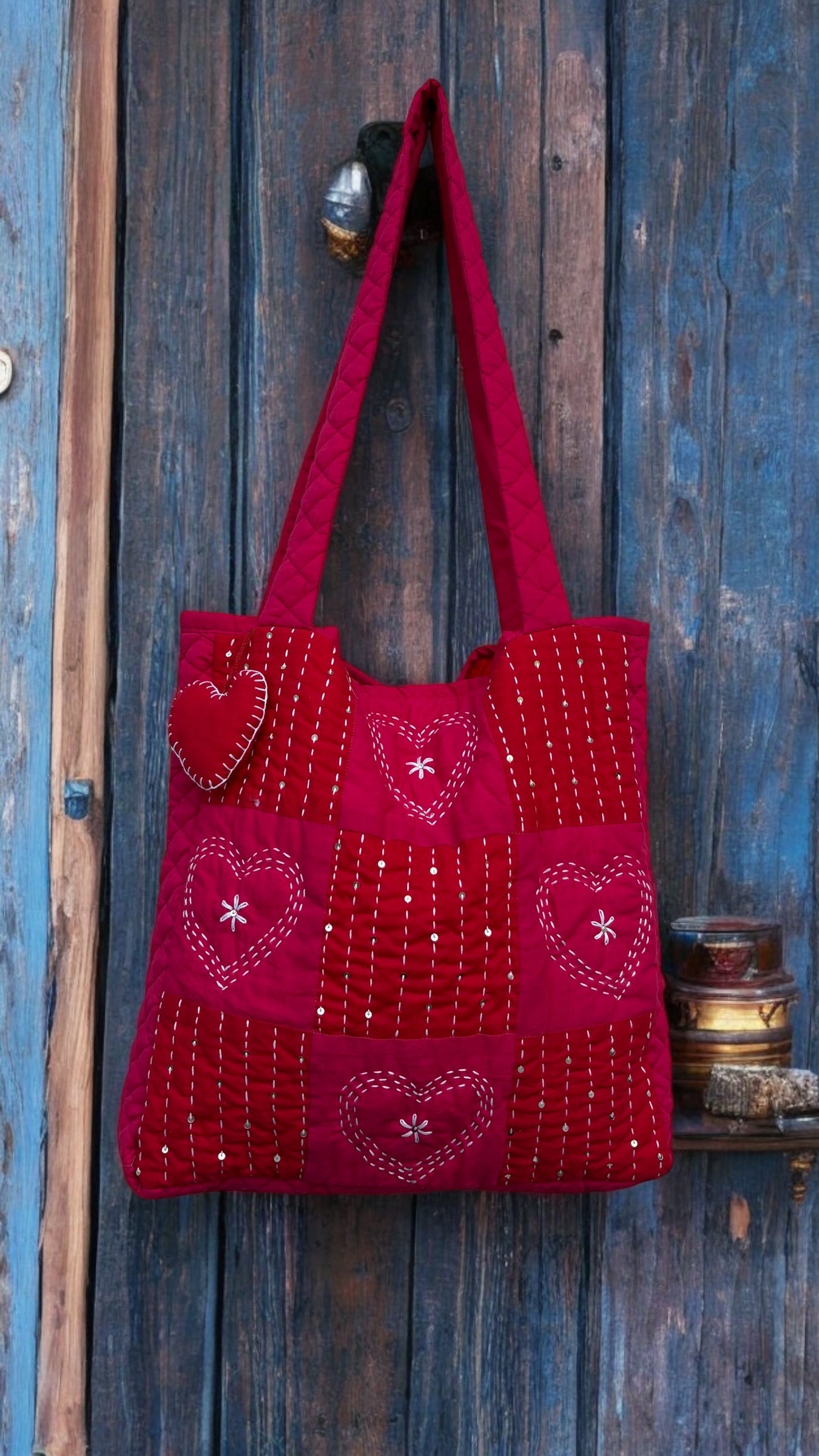 That Romeo handmade red quilted tote bag with heart-stitch Kantha embroidery and charm — made from upcycled fabric, eco-friendly and artisan-crafted

