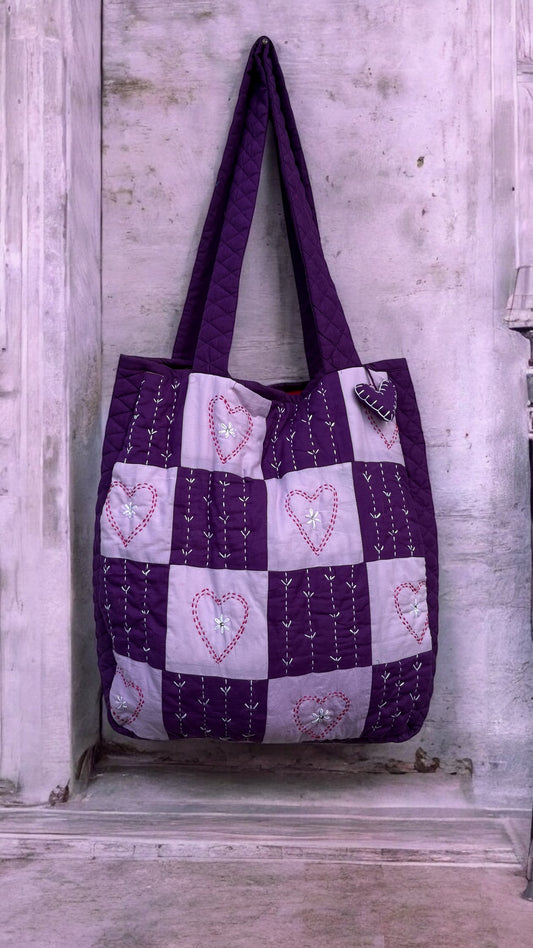 Handmade purple and lavender tote bag with heart-shaped Kantha embroidery, quilted design, and heart charm — eco-friendly and artisan-crafted by That Romeo