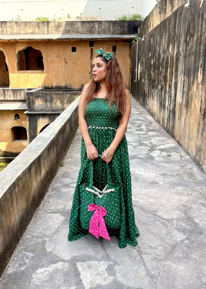 Woman in a green dress with white polka dots and Green Bandhani quilted tote bag with pink bow by That Romeo