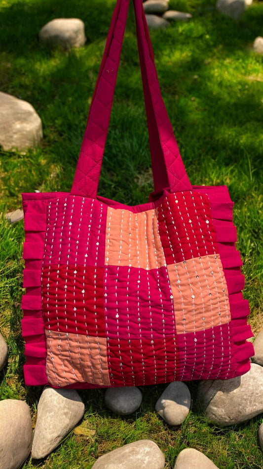 Handmade pink and coral quilted tote bag with Kantha embroidery, ruffle trim, and upcycled patchwork design — That Romeo’s artisan-crafted carryall