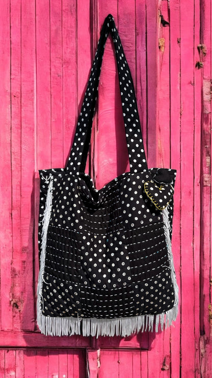 That Romeo handmade tote bag in black and white polka dots with fringe detail, Kantha stitching, and a heart charm — quilted and upcycled with artisan love