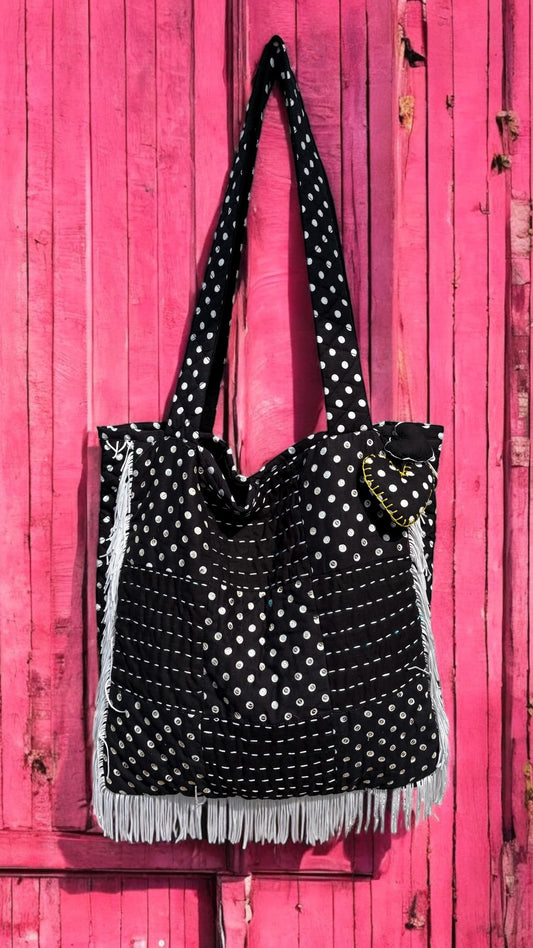 That Romeo handmade tote bag in black and white polka dots with fringe detail, Kantha stitching, and a heart charm — quilted and upcycled with artisan love