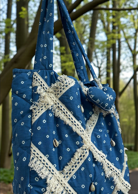 Blue Bandhani quilted tote bag by That Romeo with lace patchwork and shell embellishments.