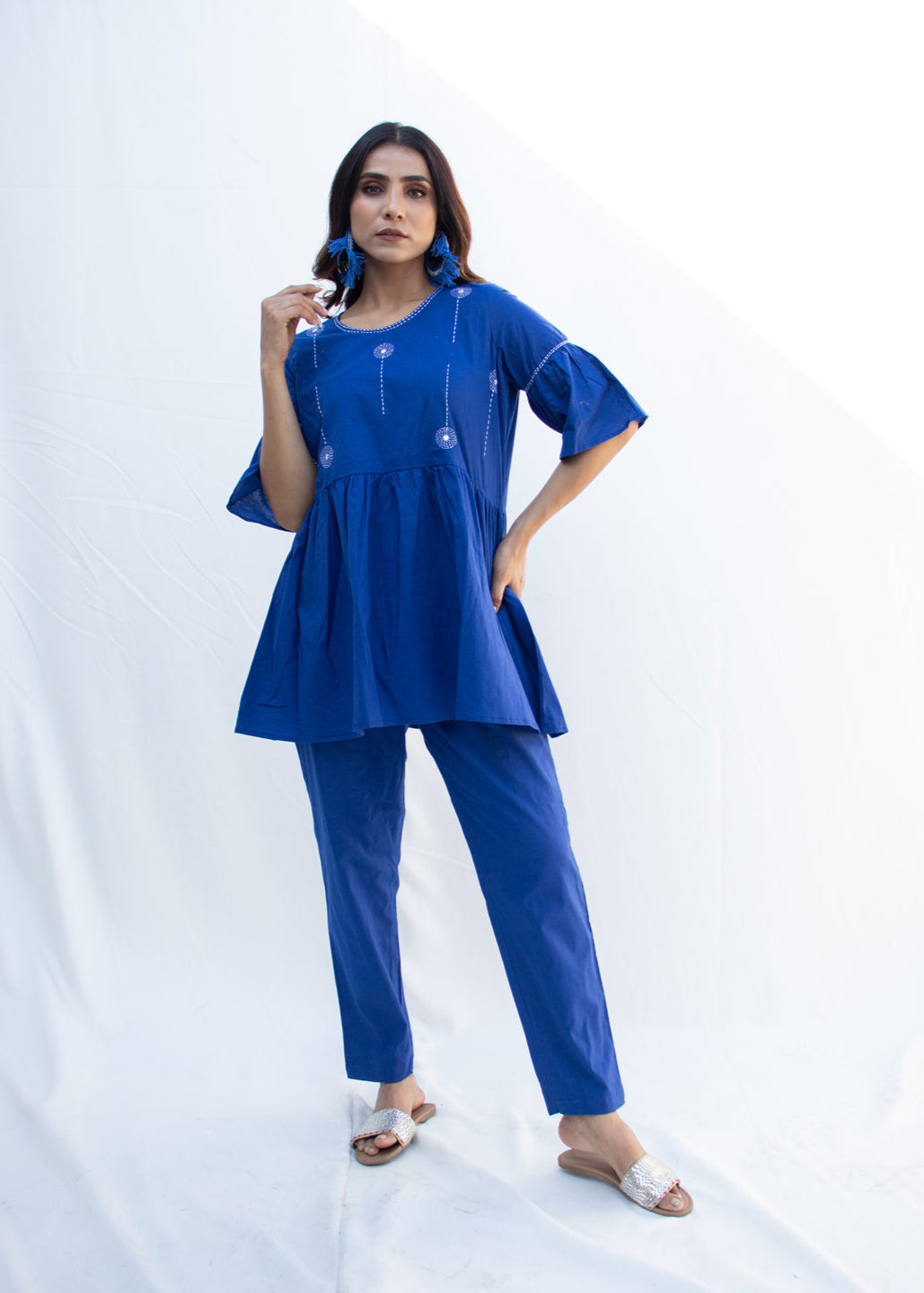 Model wearing the BIA blue cotton co-ord set with minimal white Katha embroidery, flared sleeves, and empire waist – a relaxed boho-style outfit from That Romeo’s PARDESI Collection.