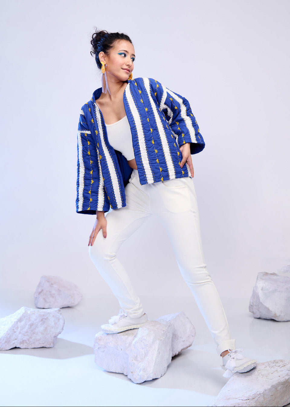 Model wearing ThatRomeo’s Azure Lane Quilted Jacket — blue and white striped cotton jacket with yellow detailing and relaxed fit.