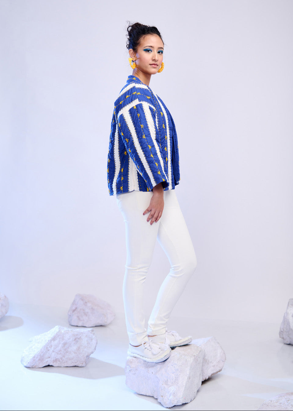 Model wearing ThatRomeo’s Azure Lane Quilted Jacket — blue and white striped cotton jacket with yellow detailing and relaxed fit.