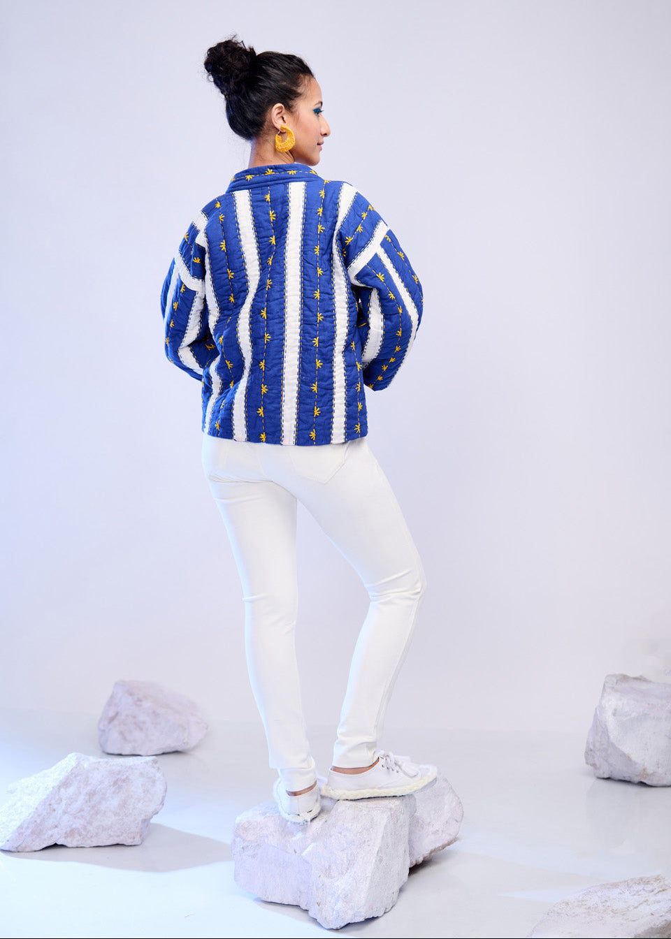 Model wearing ThatRomeo’s Azure Lane Quilted Jacket — blue and white striped cotton jacket with yellow detailing and relaxed fit.