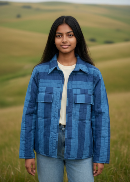 Model wearing ThatRomeo Blue Horizon Stripline Jacket — quilted cotton jacket in layered blue stripes with utility pockets.