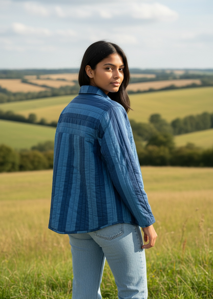 Model wearing ThatRomeo Blue Horizon Stripline Jacket — quilted cotton jacket in layered blue stripes with utility pockets.