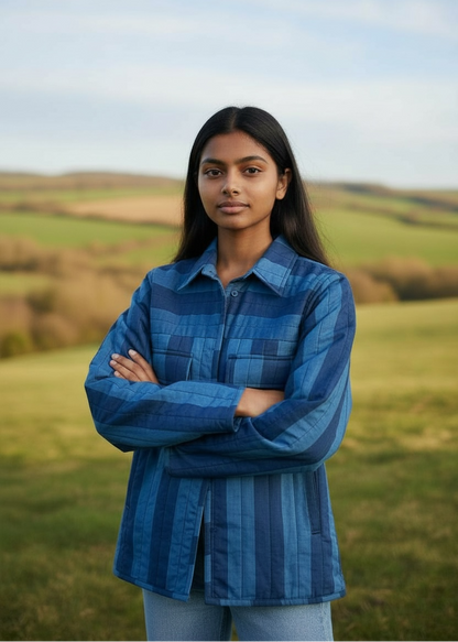Model wearing ThatRomeo Blue Horizon Stripline Jacket — quilted cotton jacket in layered blue stripes with utility pockets.
