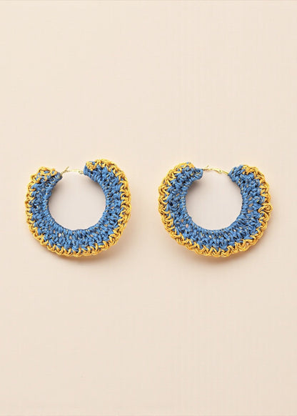Blue crochet hoop earrings with gold chain detailing by ThatRomeo on a cream background.