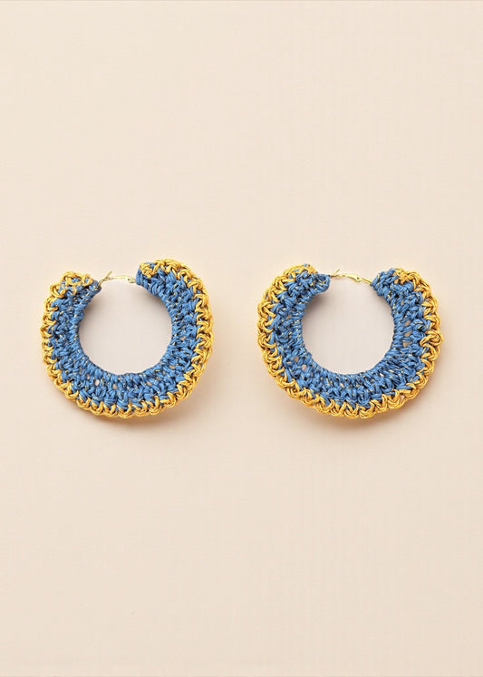 Blue crochet hoop earrings with gold chain detailing by ThatRomeo on a cream background.