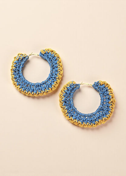 Blue crochet hoop earrings with gold chain detailing by ThatRomeo on a cream background.