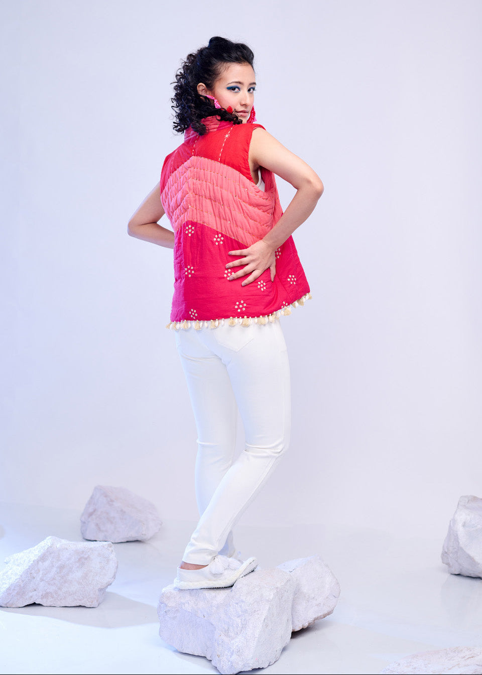 Model wearing ThatRomeo’s Blush Mirage Quilted Vest — blush and red cotton sleeveless jacket with tassel trim and mirror-inspired detailing.