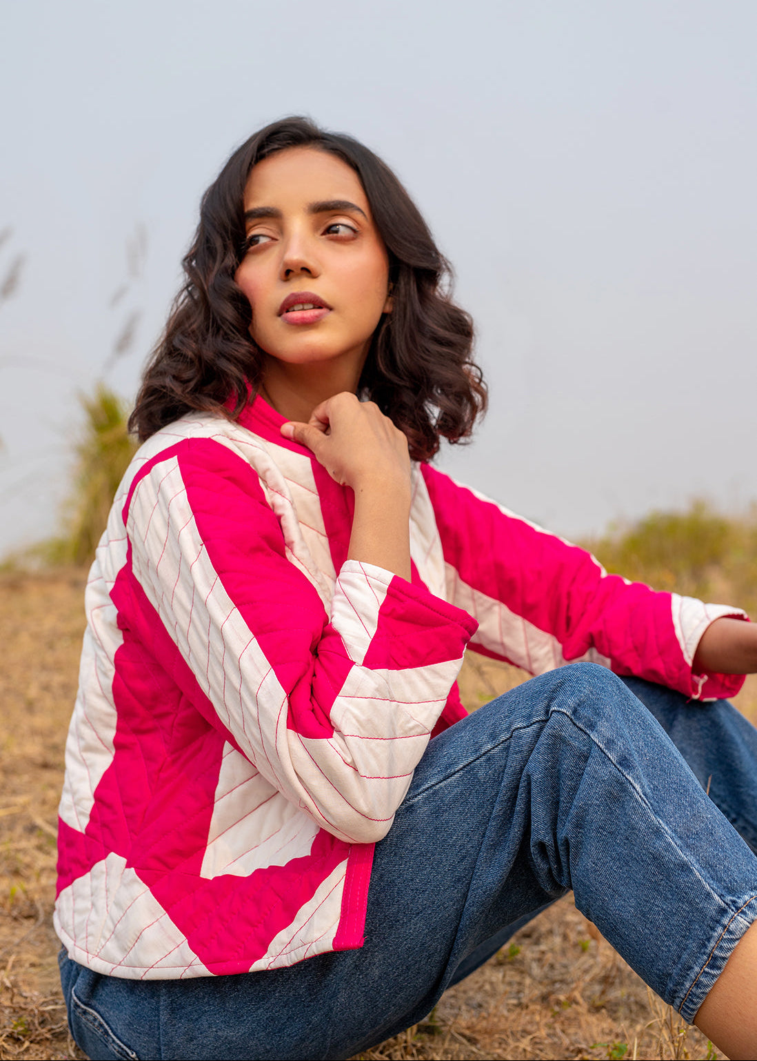 Model wearing ThatRomeo’s Candy Bolt Quilted Jacket — fuchsia and ivory cotton jacket with geometric pattern and open front.