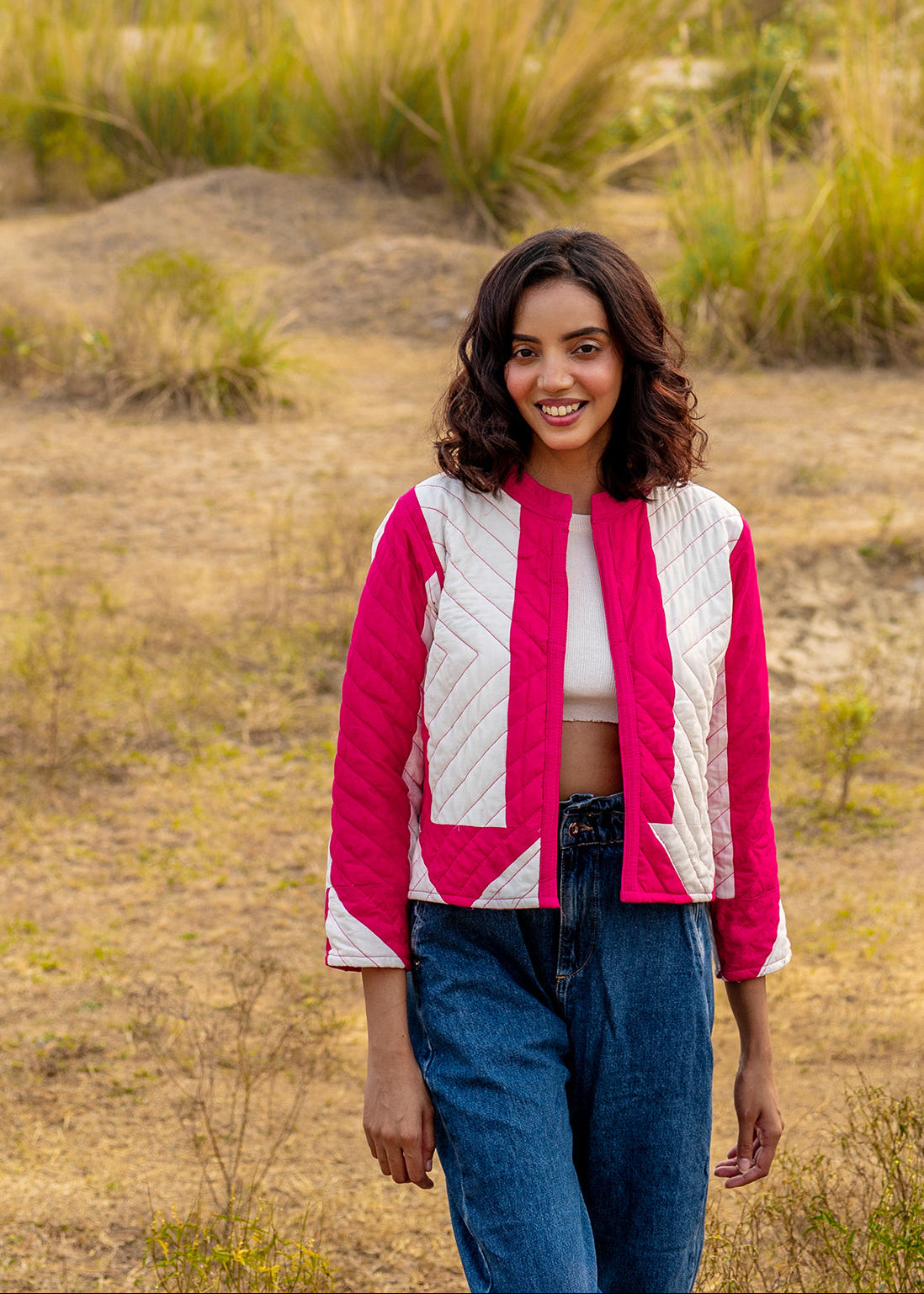Model wearing ThatRomeo’s Candy Bolt Quilted Jacket — fuchsia and ivory cotton jacket with geometric pattern and open front.