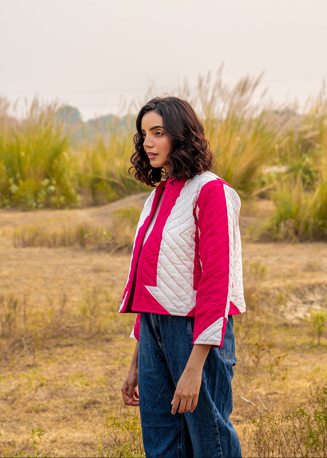 Model wearing ThatRomeo’s Candy Bolt Quilted Jacket — fuchsia and ivory cotton jacket with geometric pattern and open front.
