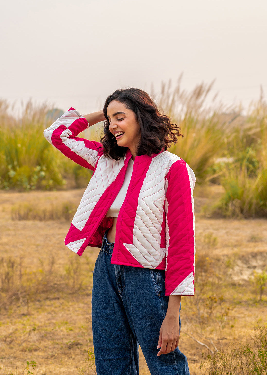 Model wearing ThatRomeo’s Candy Bolt Quilted Jacket — fuchsia and ivory cotton jacket with geometric pattern and open front.