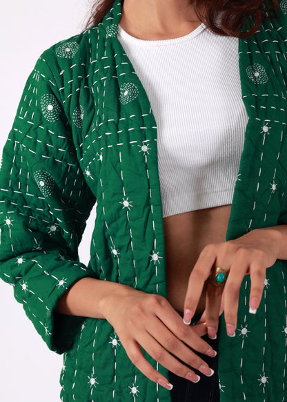 Model wearing ThatRomeo’s Emerald Echo Quilted Jacket — emerald green cotton jacket with white thread embroidery and open front.