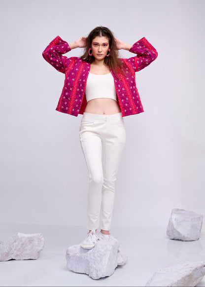 Model wearing ThatRomeo’s Fuchsia Bloom Quilted Jacket — bright fuchsia cotton jacket with white embroidery, styled with white pants.