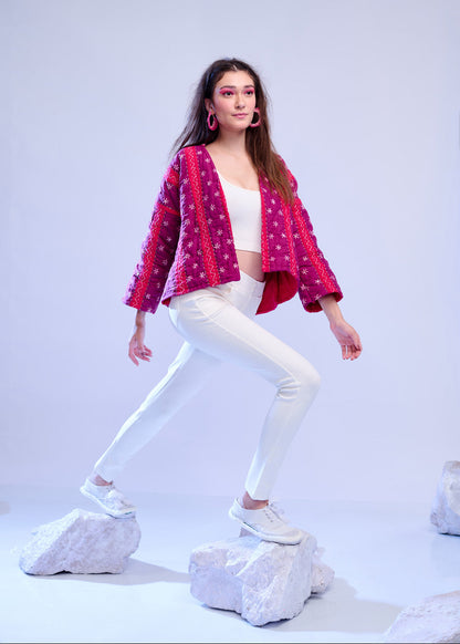 Model wearing ThatRomeo’s Fuchsia Bloom Quilted Jacket — bright fuchsia cotton jacket with white embroidery, styled with white pants.