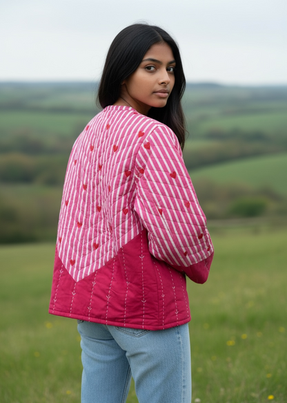 Model wearing ThatRomeo’s Heartline Quilted Jacket — pink striped cotton jacket with red heart embroidery and relaxed fit.