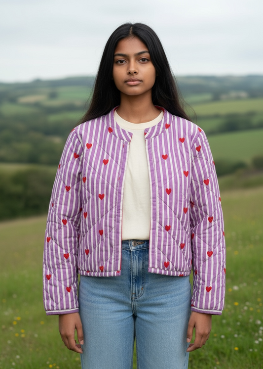 Model wearing ThatRomeo’s Lavender Love Quilted Jacket — lavender striped jacket with red embroidered hearts and open front.