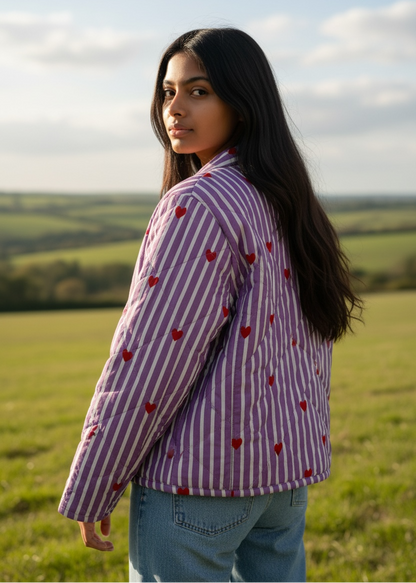 Model wearing ThatRomeo’s Lavender Love Quilted Jacket — lavender striped jacket with red embroidered hearts and open front.