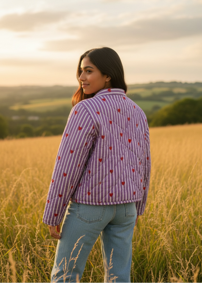 Model wearing ThatRomeo’s Lavender Love Quilted Jacket — lavender striped jacket with red embroidered hearts and open front.