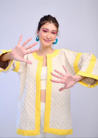 Model wearing ThatRomeo’s Lemon Drift Quilted Jacket — off-white cotton jacket with yellow borders and relaxed fit.