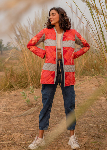 Model wearing ThatRomeo’s Maple Squarzy Patchwork Jacket — grey and red geometric quilted jacket in longline silhouette.