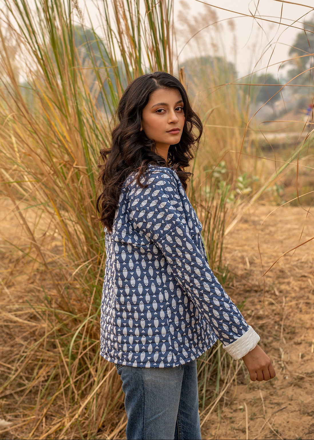 Model wearing ThatRomeo’s Memories Quilted Jacket — indigo printed cotton jacket with pockets and reversible cuff detail.