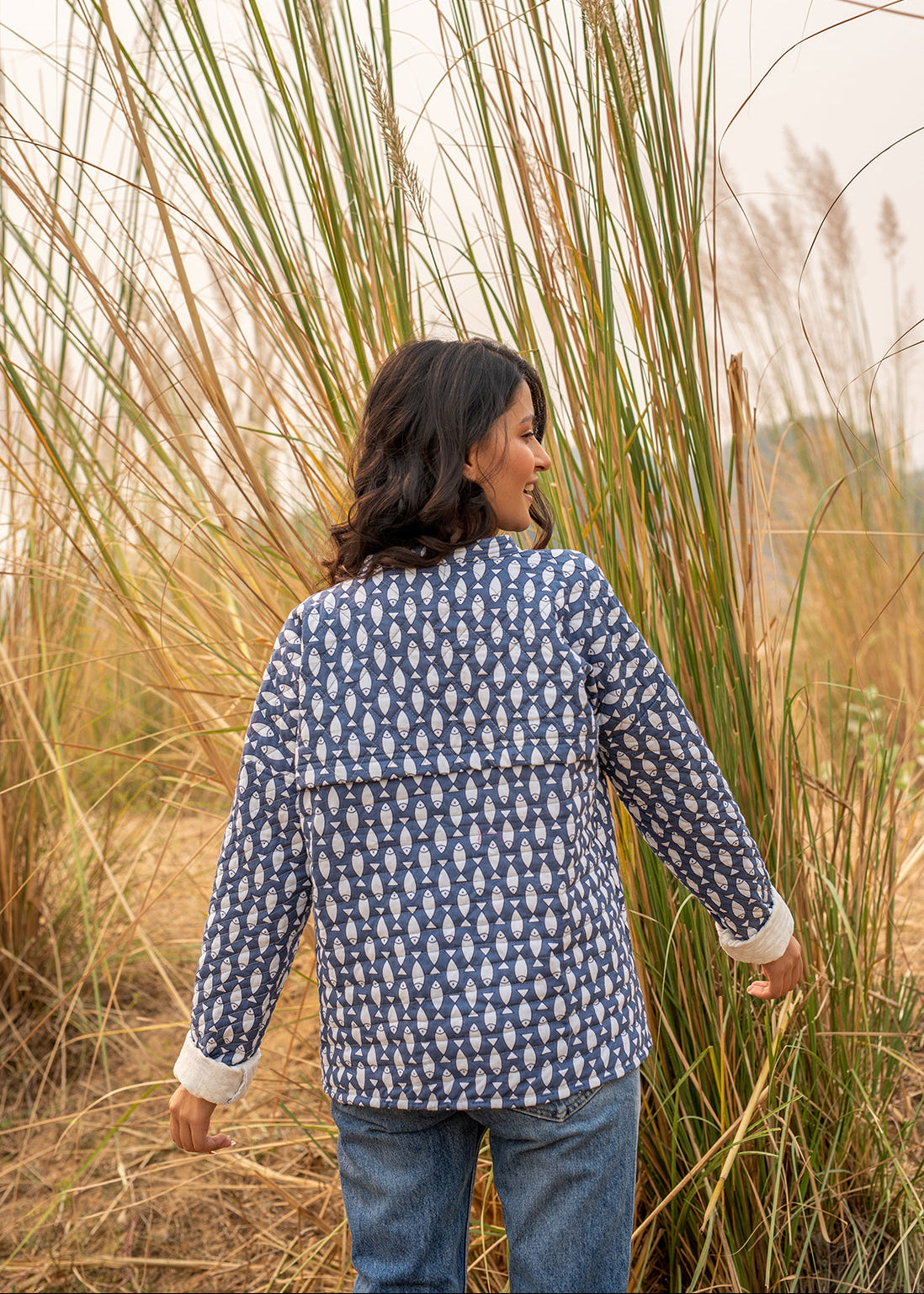 Model wearing ThatRomeo’s Memories Quilted Jacket — indigo printed cotton jacket with pockets and reversible cuff detail.