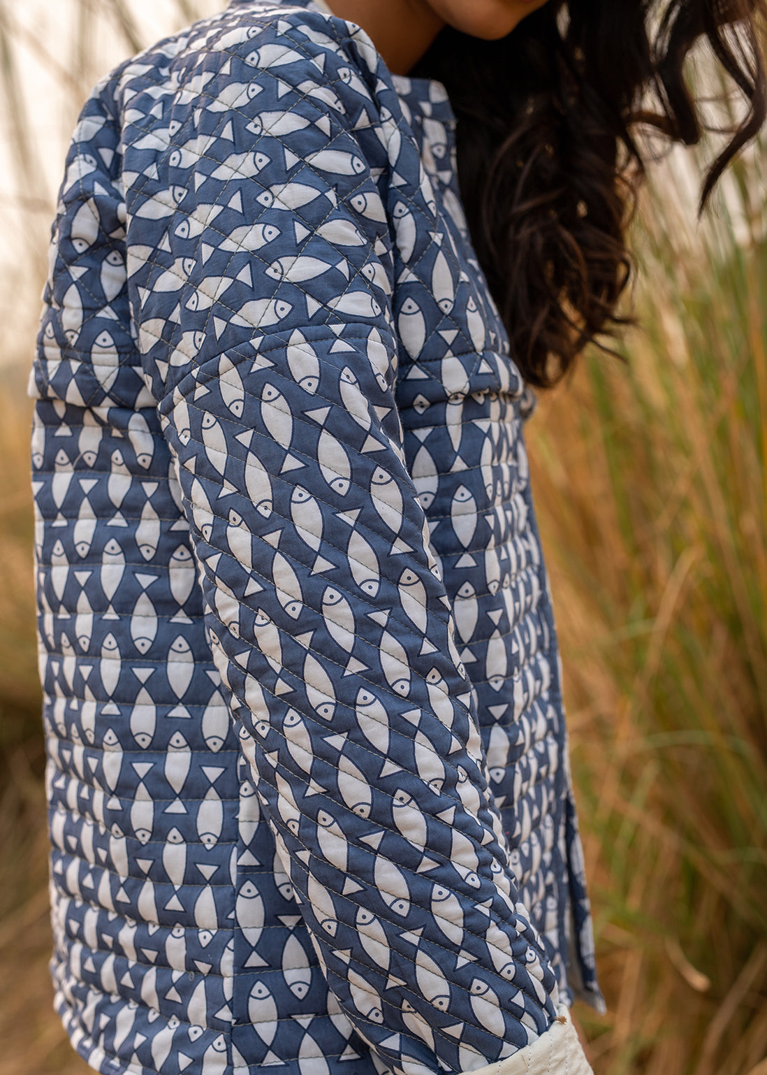 Model wearing ThatRomeo’s Memories Quilted Jacket — indigo printed cotton jacket with pockets and reversible cuff detail.