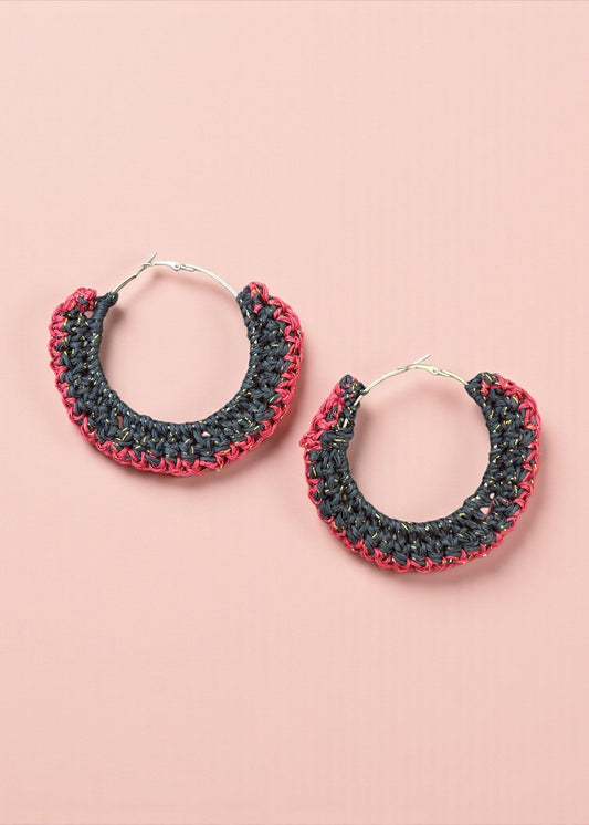 Charcoal black and red crochet hoop earrings by ThatRomeo on a blush background.