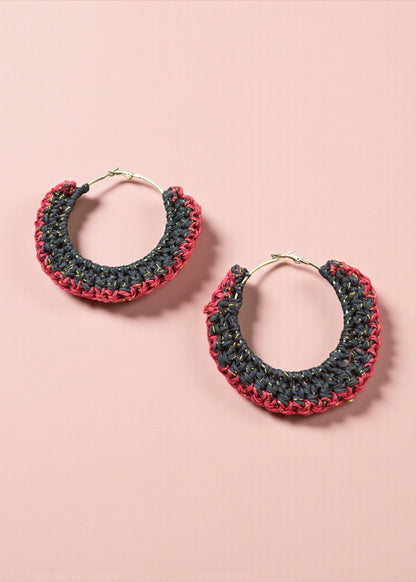 Charcoal black and red crochet hoop earrings by ThatRomeo on a blush background.
